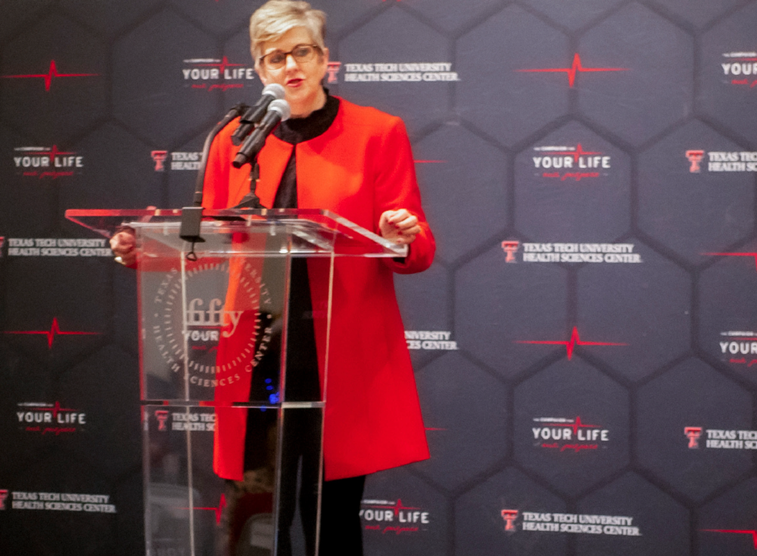 Lori Rice-Spearman speaking at a podium