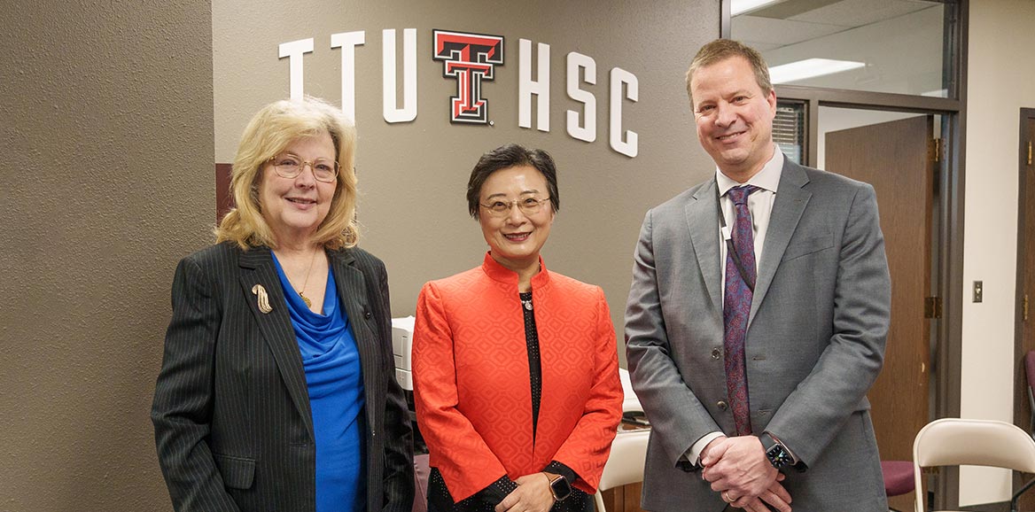 Alyce S. Ashcraft, Holly Wei, and Jason Glikas standing infront of the center entrance