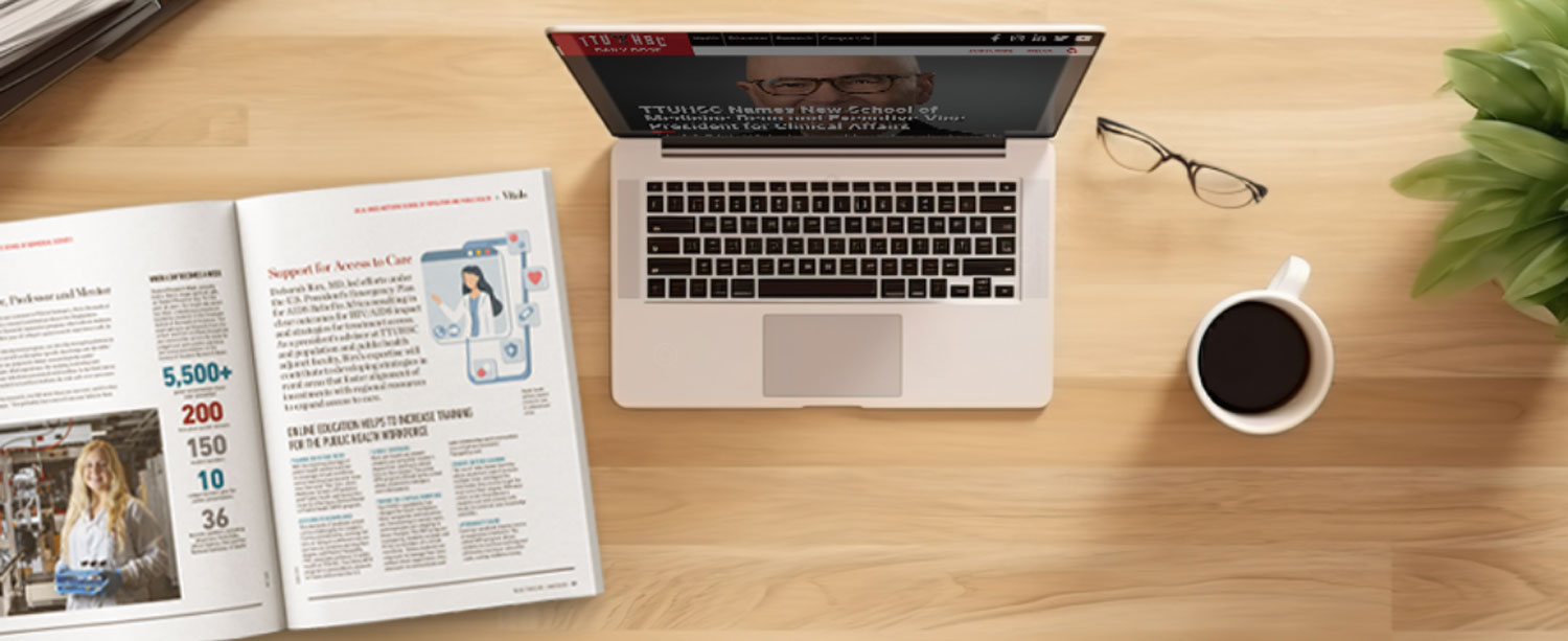 desk with magazine and laptop