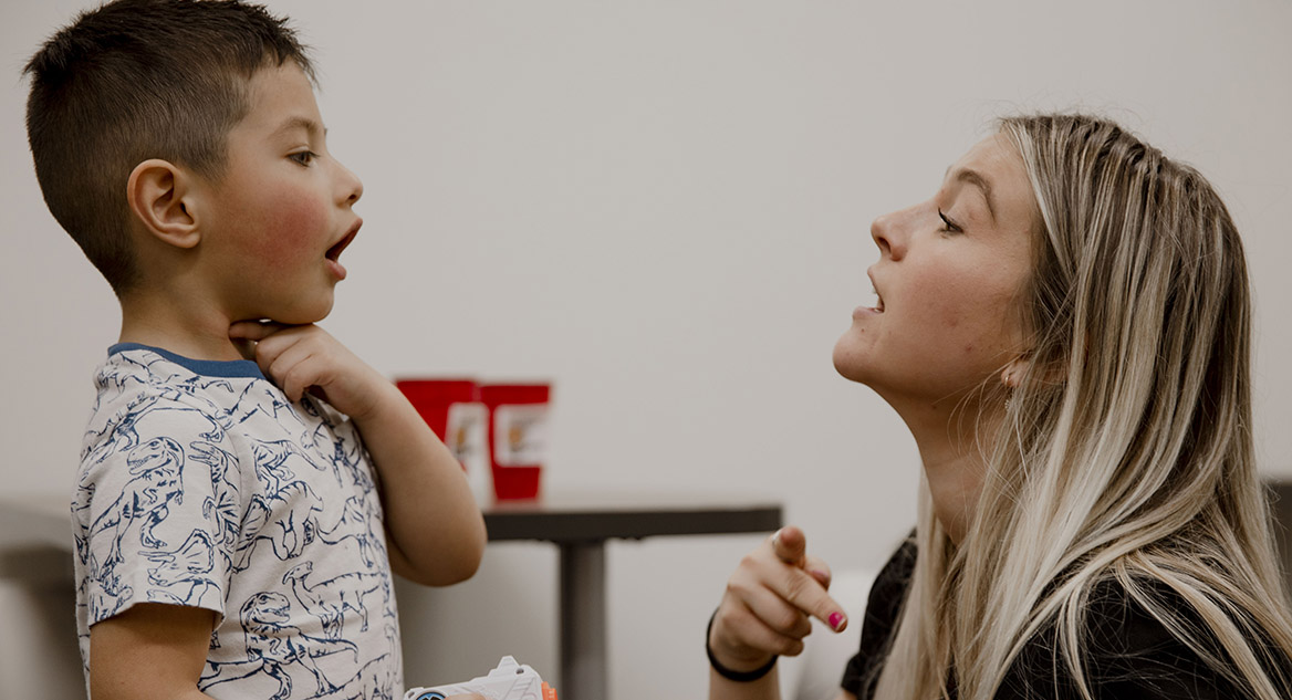 A Student interacts with a child in the SLHS Clinic