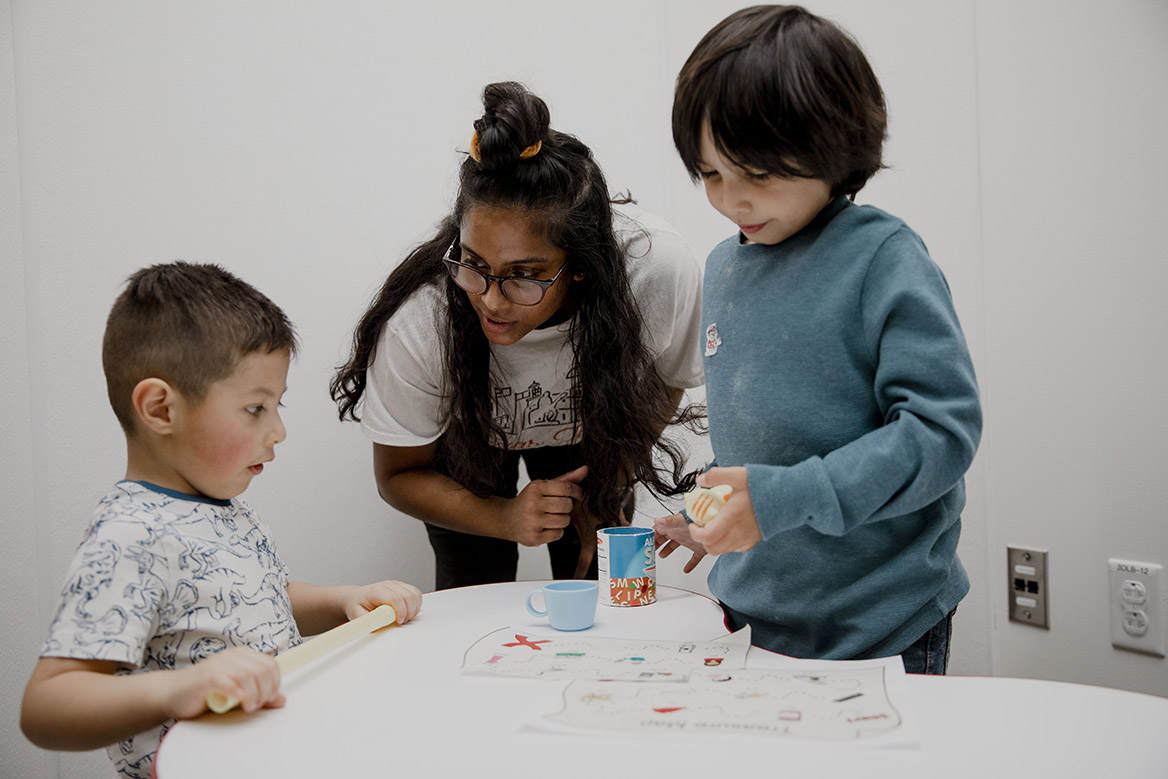 An SLHS student works with children in the clinic