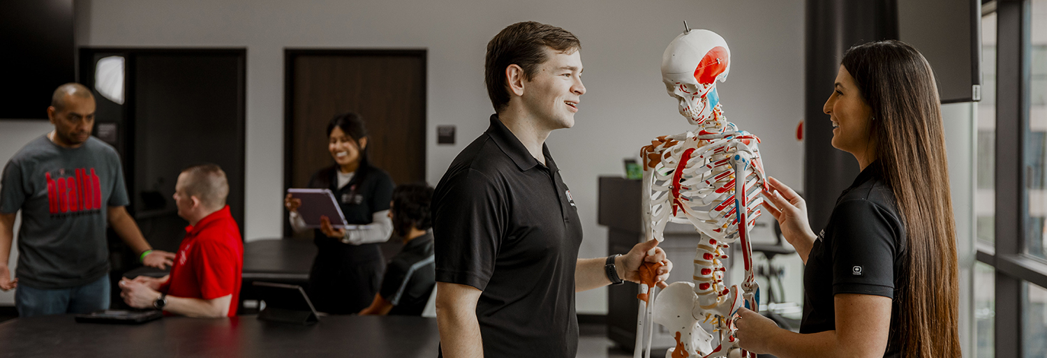 SHP students in a lab with a skelton model