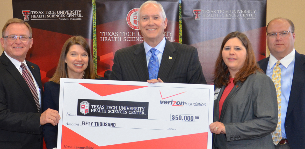 Verizon check being presented to TTUHSC for children's diabetes management program.