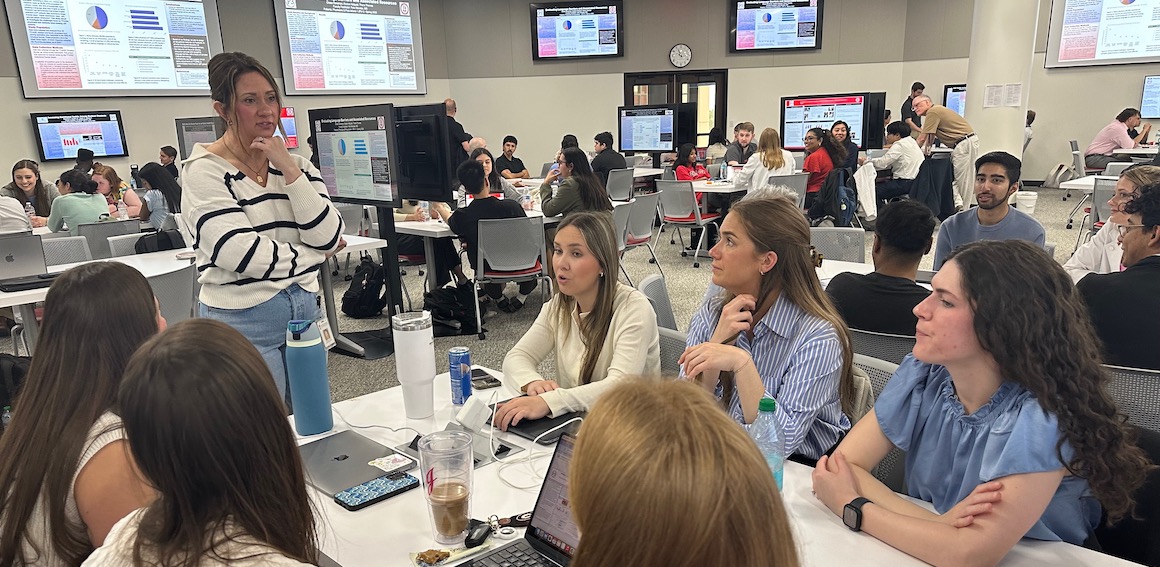  DOME students sitting around a table smiling and conversing