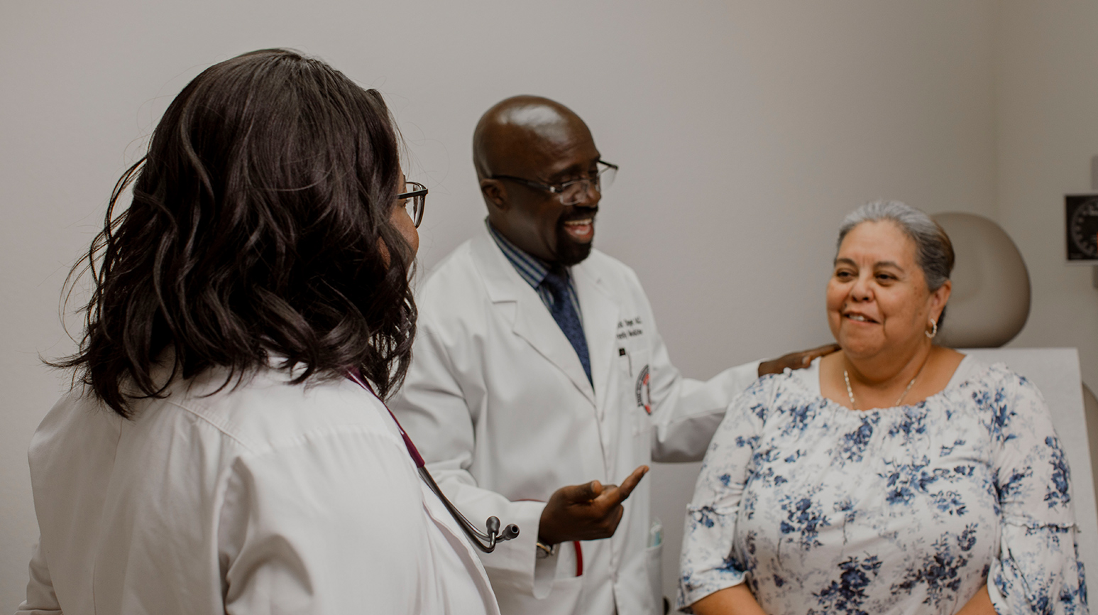 Provider assisting patient sitting in patients room