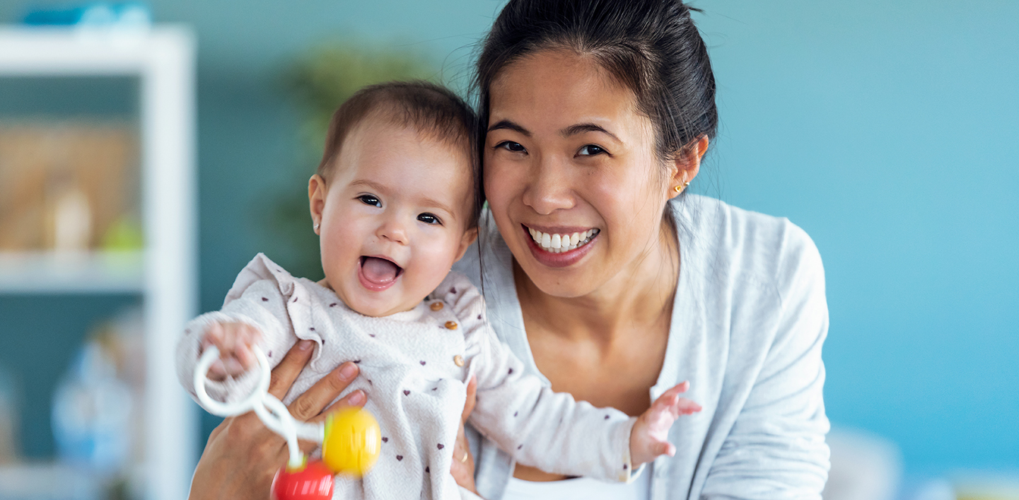 Mother holding toddler daughter