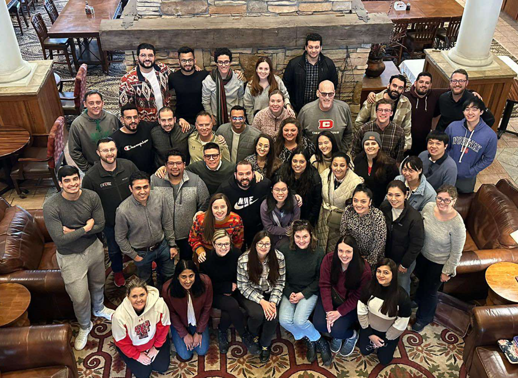 Group of TTUHSC Internal Medicine Resident's in a lodge looking up smiling Group of TTUHSC Internal Medicine Resident's in a lodge looking up smiling