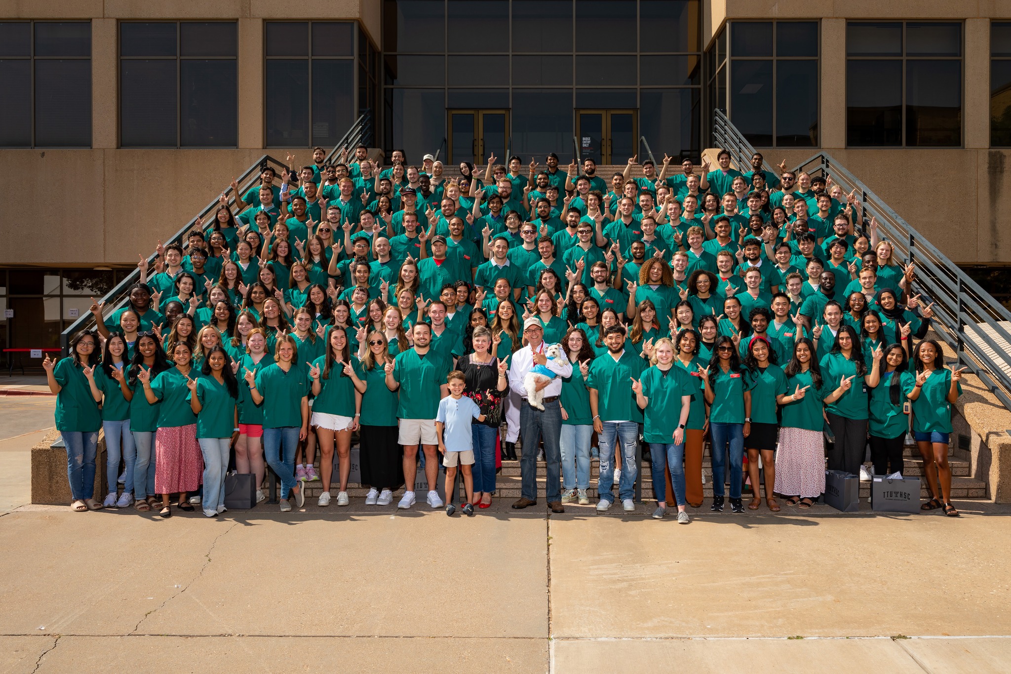 2024 Scopes and Scrubs photo of students standing infront of TTUHSC Lubbock stairway