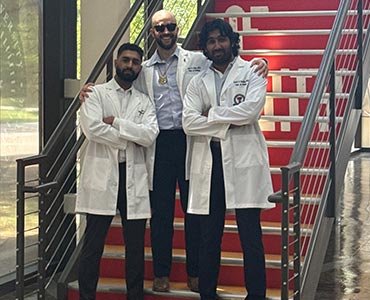 residents standing on a staircase smiling