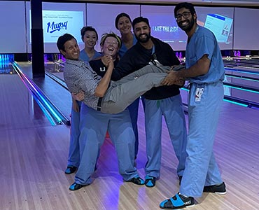 residents gathered on bowling alley lane smiling