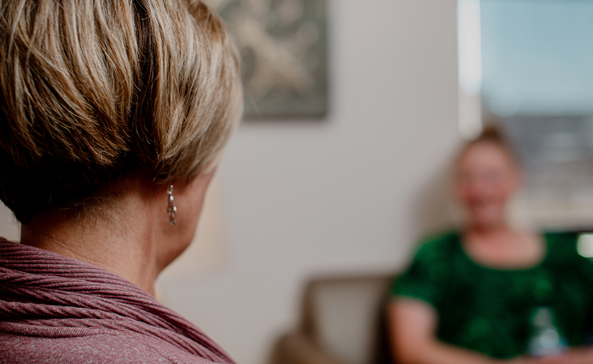 provider sitting with a patient in a therapy room