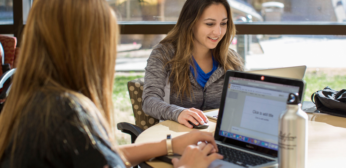 TTUHSC students in a study session working at a table with their computers.