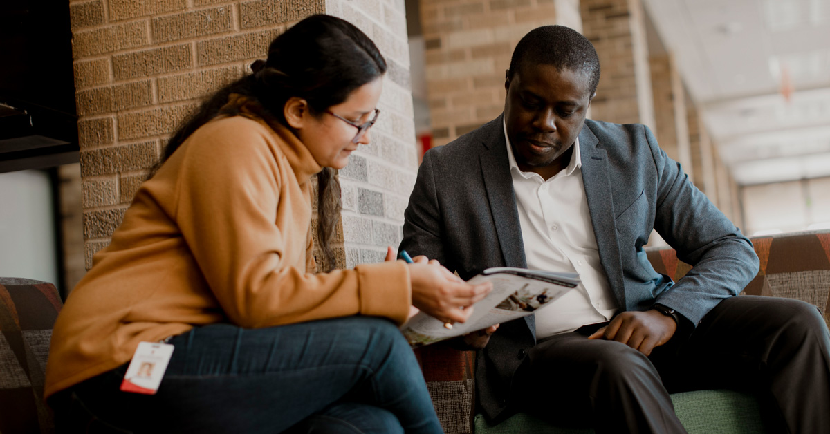 counselor reviewing course book with student