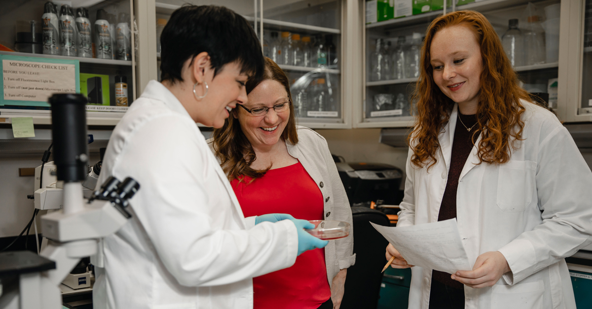 collegues in a lab dicussing lab research