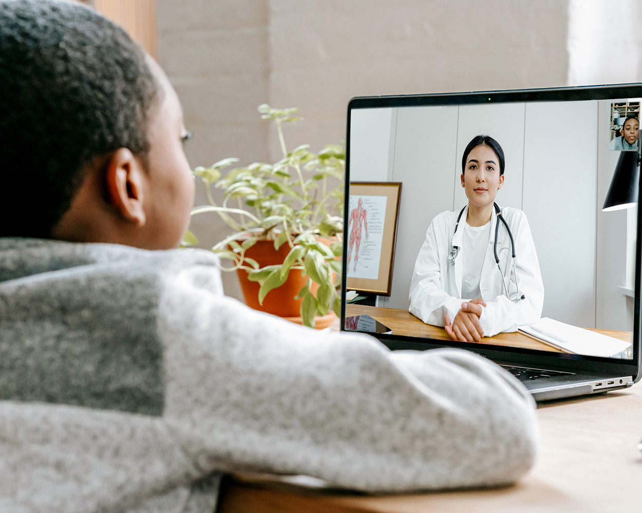 A child looking at a computer screen during a virtual appointment with a provider.