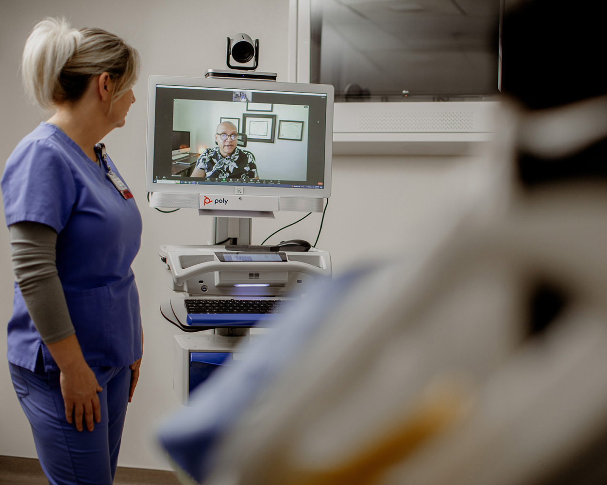 telepsych appointment with ap atient and provider standing nearby