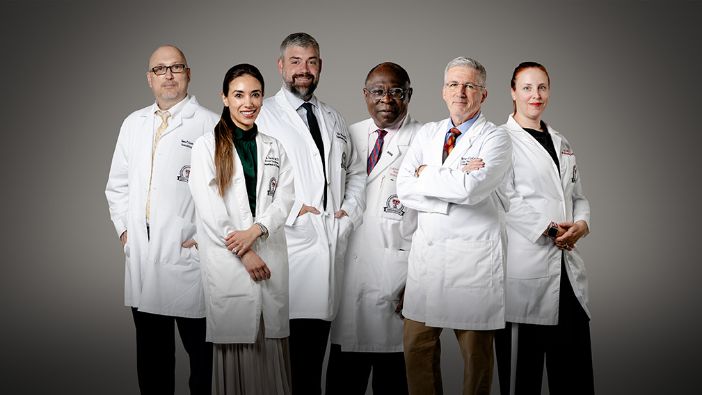 Group of expert cancer physicians facing camera