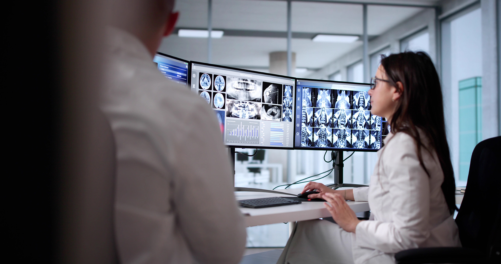 Physician reviews imaging on multiple screens