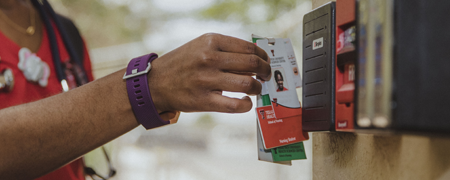 student scanning her badge for access