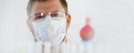 Team Member in lab with test tubes