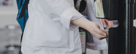 student using hand sanitizer