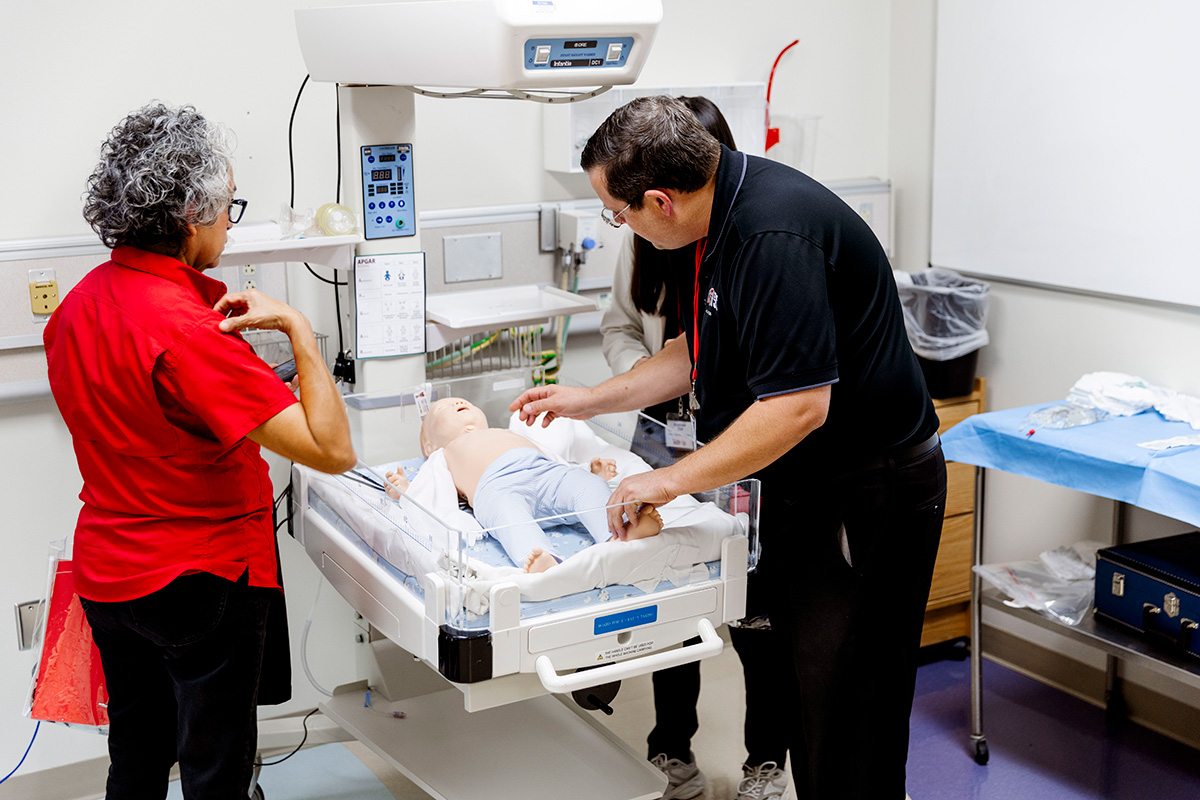 People looking at simulation dummy