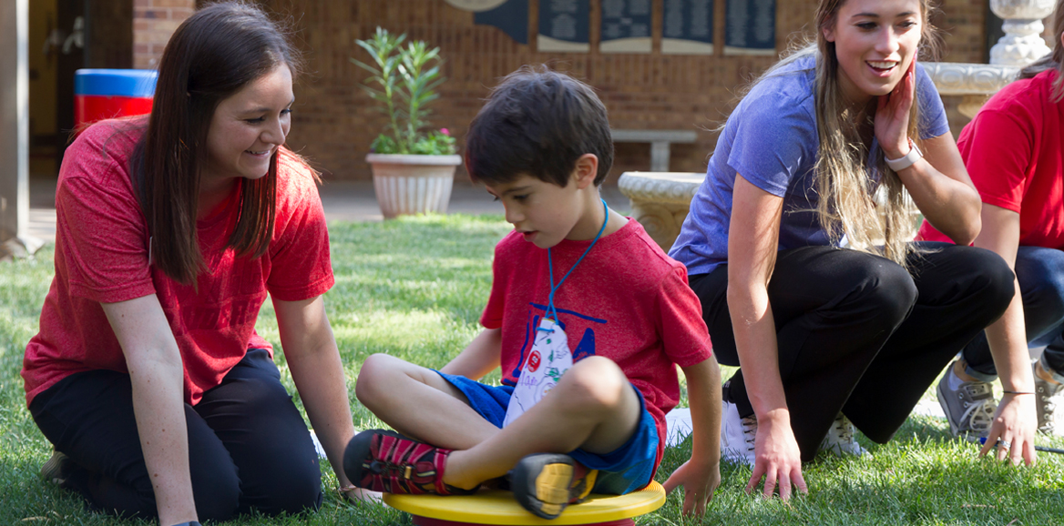 Student playing with child