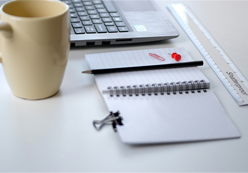 desk with notebooks and coffe mug 