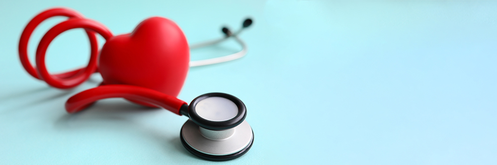 red heart and stethoscope on a blue background